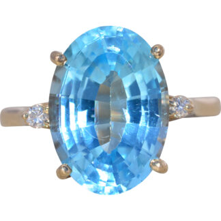 The Azure Elongation: Oval Blue Topaz and Natural Diamond Ring in Yellow Gold