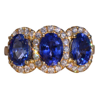 The Mount Rainier: Three Stone Tanzanite Ring with Diamond Halo in Yellow Gold