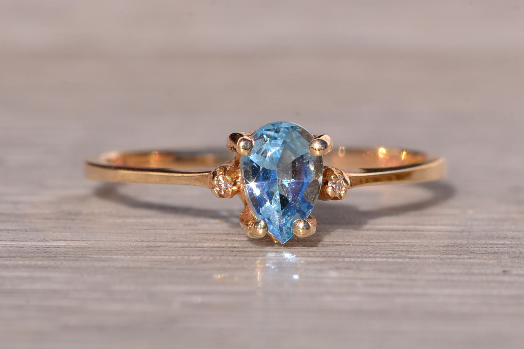 The Tint: Pear Shaped Swiss Blue Topaz and Natural Diamond Ring in Yellow Gold - Image 2