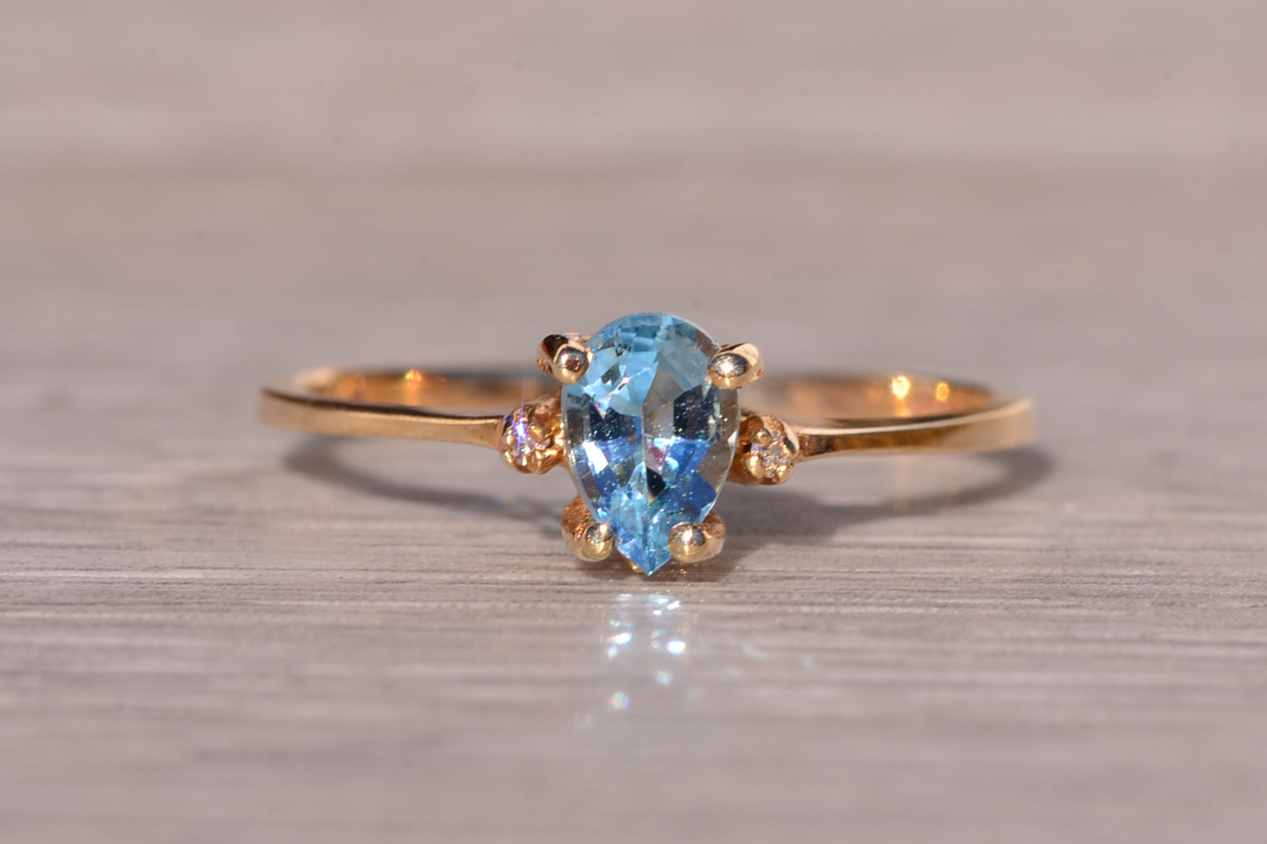 The Tint: Pear Shaped Swiss Blue Topaz and Natural Diamond Ring in Yellow Gold - Image 3