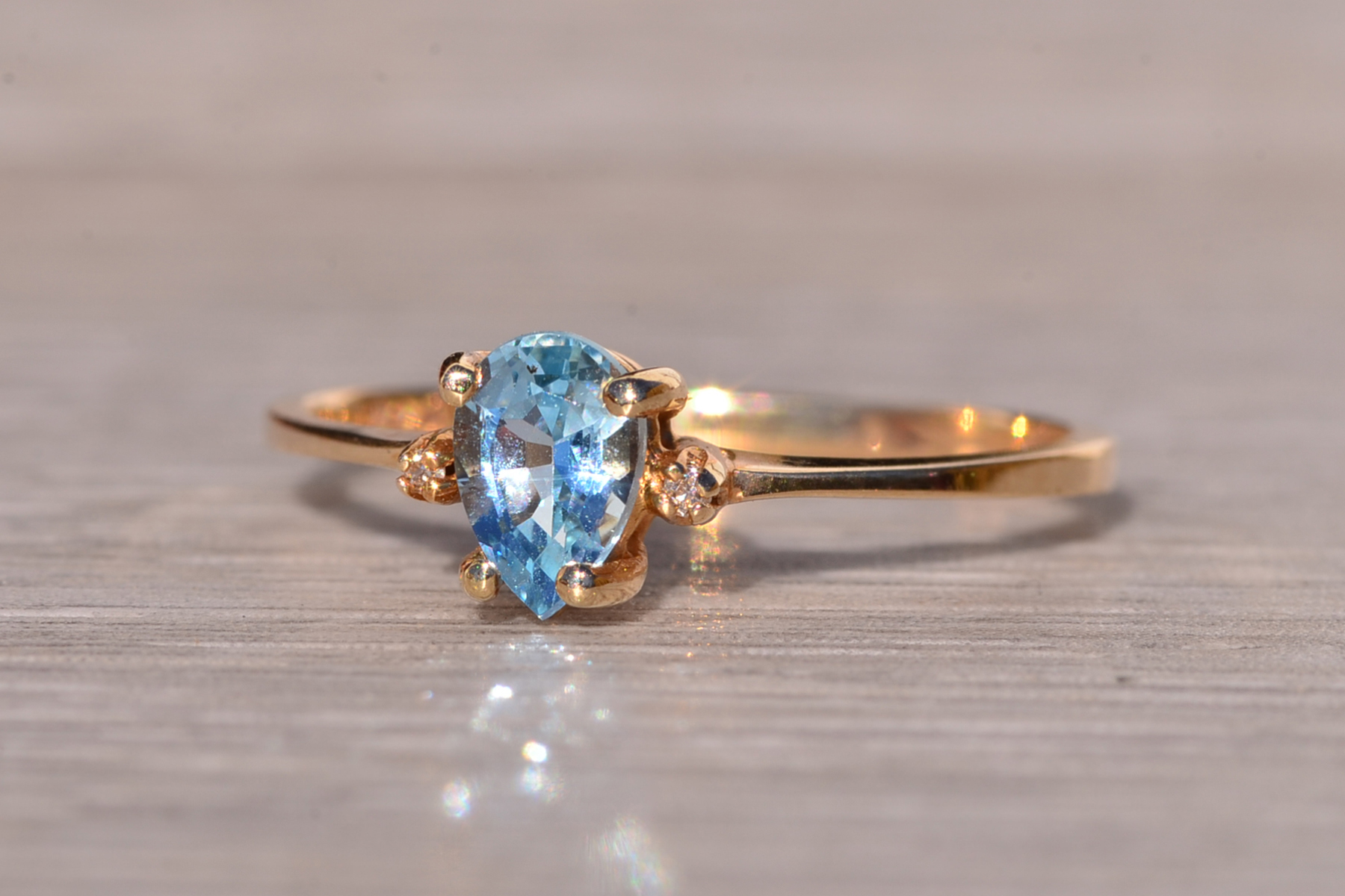 The Tint: Pear Shaped Swiss Blue Topaz and Natural Diamond Ring in Yellow Gold - Image 4