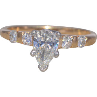 The Golden Teardrop Radiance: Natural Pear Cut Diamond Engagement Ring with Accent Diamonds in Yellow Gold