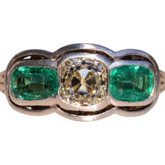 The 56th Street:  Antique Platinum Topped Engagement Ring with Old Mine Cushion Cut Natural Diamond and Colombian Emeralds