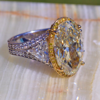 The Eveline:  8.48 Carat Oval Diamond Flanked by 0.77 Carat & 0.75 Carat Trilliant Cut Diamond