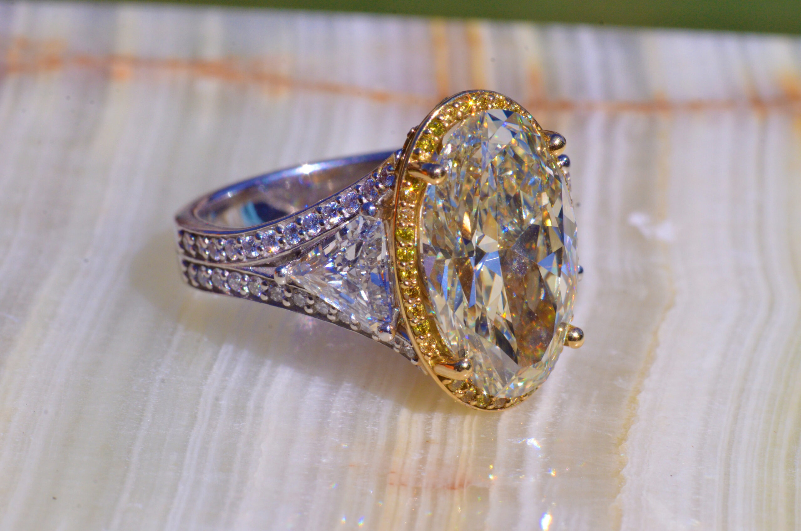 The Eveline: 8.48 Carat Oval Diamond Flanked by 0.77 Carat & 0.75 Carat Trilliant Cut Diamond